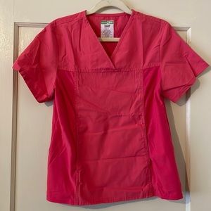 Scrub top. Has stretch side panels for comfort. Two pockets. Good condition.